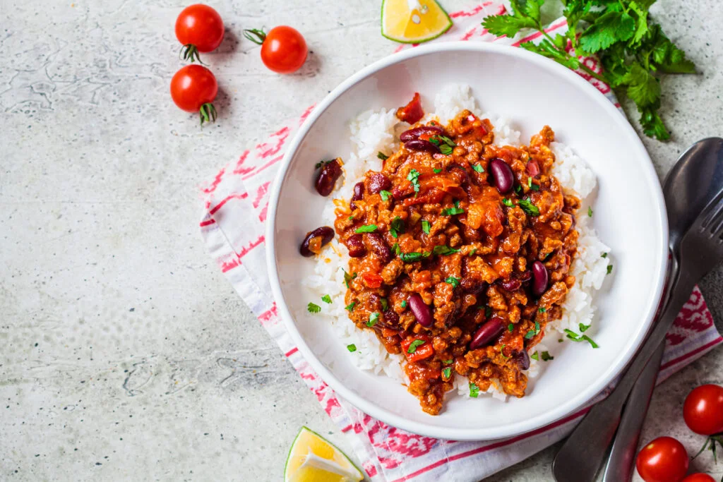 Chili con carne with rice in white bowl